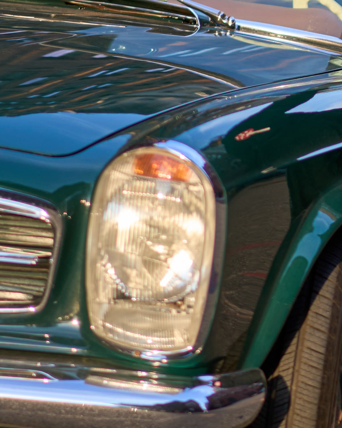 The vintage green Mercedes convertible in golden evening light on a Manhattan street